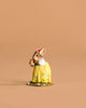 The Wee Forest Folk Tiny Collectible - Bluebird of Happiness (Not a Toy) features a charming rabbit in a yellow dress with flowers and a crown, holding a brown jug—ideal for collectors of hand-sculpted miniatures.