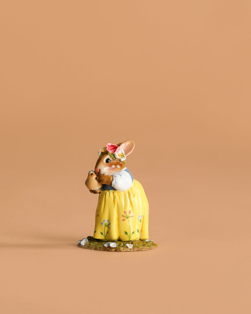 The Wee Forest Folk Tiny Collectible - Bluebird of Happiness (Not a Toy) features a charming rabbit in a yellow dress with flowers and a crown, holding a brown jug—ideal for collectors of hand-sculpted miniatures.