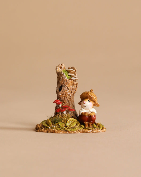 The Wee Forest Folk Tiny Collectible – My Happy Place (Not a Toy) features a smiling gnome in a straw hat and brown pants beside a tree stump with red mushrooms on grass, capturing classic Wee Forest Folk charm against a beige backdrop.