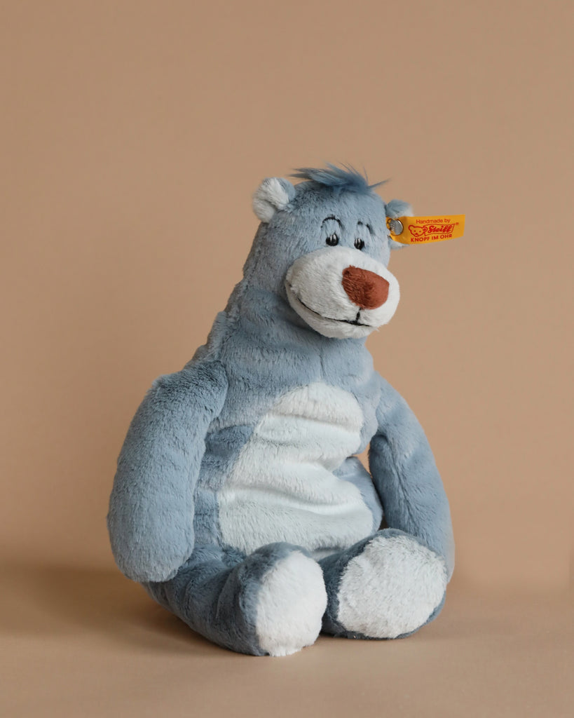 A Steiff Disney's "Jungle Book" Baloo Bear plush toy, characterized by its delightful tag that perfectly captures Baloo's charming character.