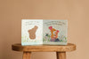 An open copy of "I Love You So" by Patricia Hegarty rests on a wooden stool. The left page features a mouse cut-out with, "Mommy mouse and baby are snuggled face to face," while the right shows baby animals hugging: "It’s my favorite place!.