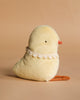 The Maileg Easter Egg With Chick features a soft, plush cream yellow chick with an orange beak and feet, black eyes, and a white lace collar—perfect for adding charm to your Easter egg display.