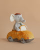 The Elephant Driver Plush Toy features a plush elephant with a brown hat and green tie sitting on a stuffed car, creating an adorable two-in-one plushie displayed against a plain beige background.