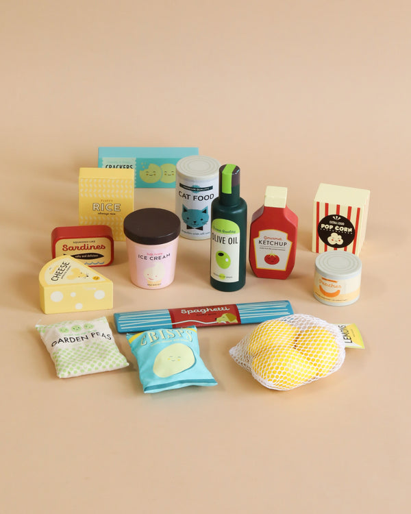 A collection of colorful, playful Grocery Set items including packages of rice, cat food, olive oil, ketchup, popcorn, peas, baby wipes, sardines, and ice cream.