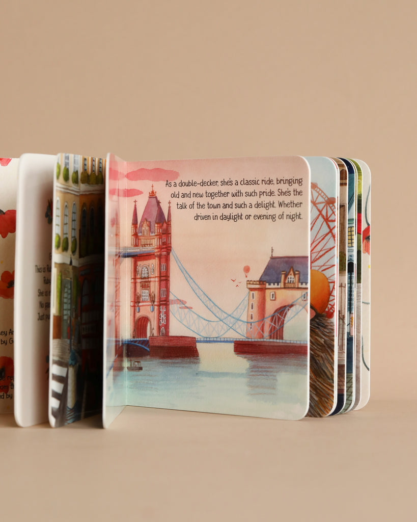A deck of illustrated playing cards featuring famous London landmarks, including greener transportation like Ruby The Red Electric Bus and Tower Bridge, spread out on a beige background.