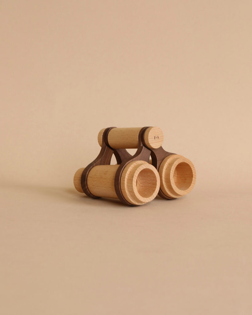 A wooden binoculars for pretend play of heirloom quality with a minimalistic design, featuring large round wheels and an open seating area, set against a plain beige background.