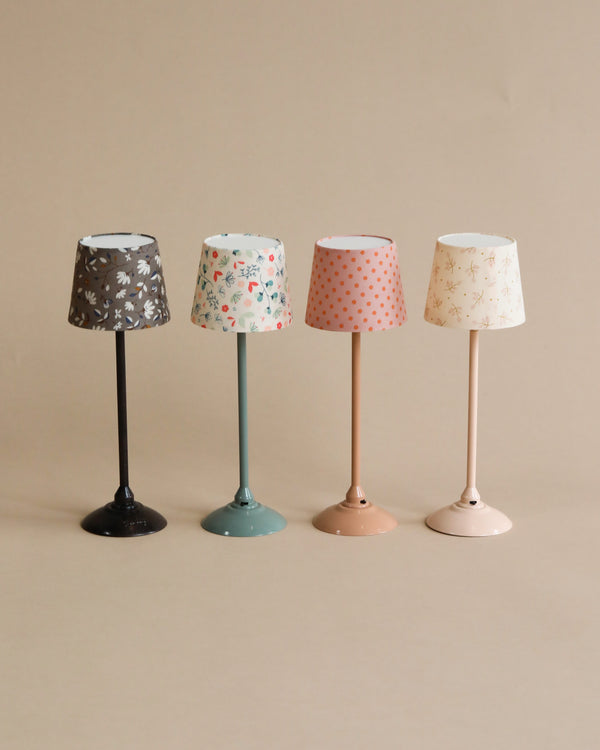 Four Maileg Miniature Floor Lamps - Tall with patterned shades, aligned in a row against a neutral background. Each lamp features a different color and pattern on both the base and shade.