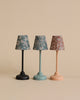 Three small decorative Maileg Vintage Mouse Lamps - Small with patterned shades in blue, green, and red, sitting in a row against a neutral background. Each lamp has a distinct colored base: black.
