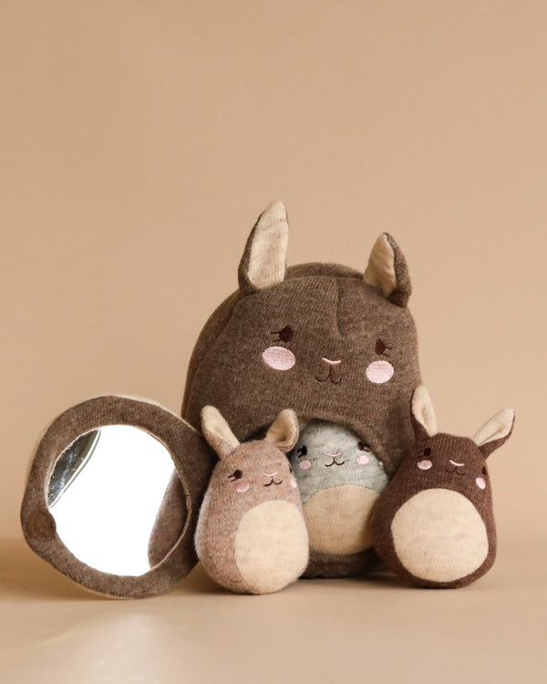Three Wooden Activity Kangaroo resembling cute, brown animals with large ears, made from organic cotton, designed by a user. The largest one is in the center, flanked by a smaller one and another with a