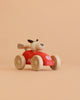 The Wooden Race Car Toy with Dog Driver from Egmont Toys features a vibrant red body, natural wood wheels, and a playful dog figure behind the wheel. Set against a plain beige background, this charming toy showcases classic red sports car appeal paired with timeless wooden craftsmanship.