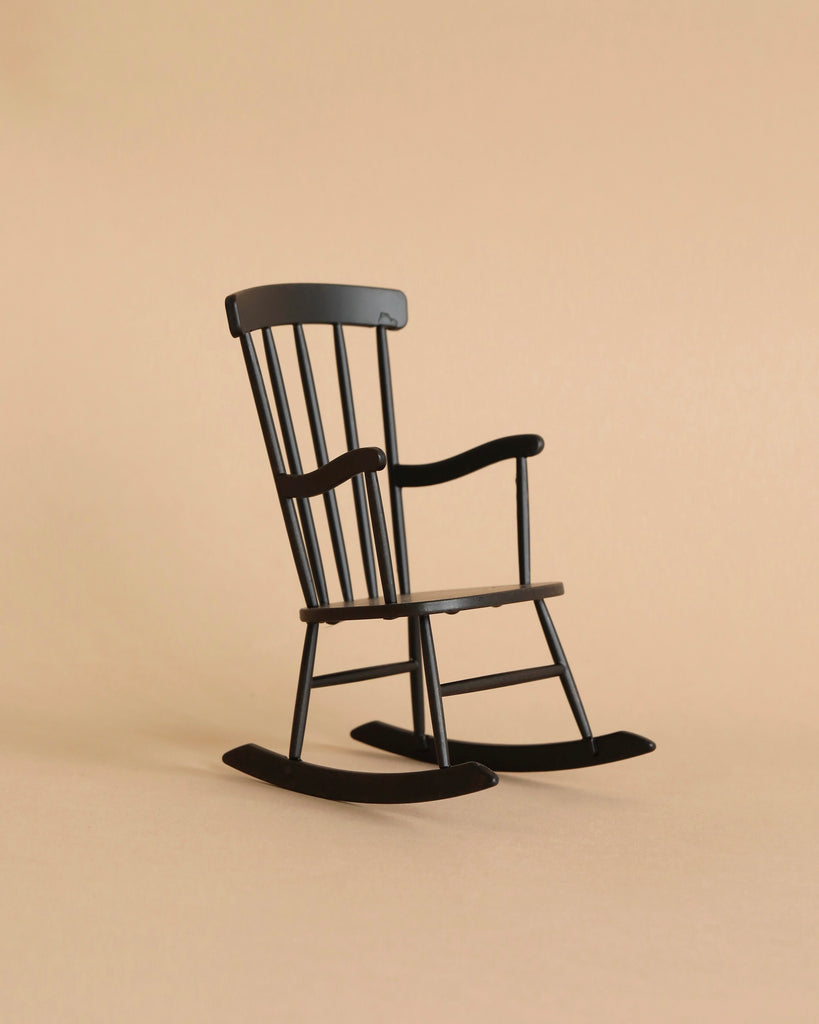 A Maileg Teddy Bedroom Set (ships in one week) featuring a small black rocking chair with vertical slats sits on a plain beige background.