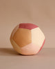 The Fabric Ball - Dusty Rose is a soft, organic cotton baby ball featuring a patchwork design in muted pink, peach, and beige tones, shown on a matching neutral background.