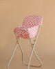 The Konges Sloejd High Chair - Rosie Rose, a beige metal foldable chair with a pink and white floral-patterned cushion and detachable seat, is shown against a plain beige background—perfect for dolls.