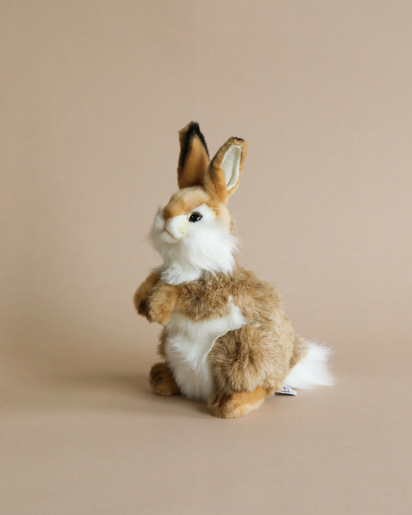 A Thumper Rabbit Stuffed Animal crafted with high-quality materials, featuring brown and white fur, standing upright on its hind legs against a solid beige background.