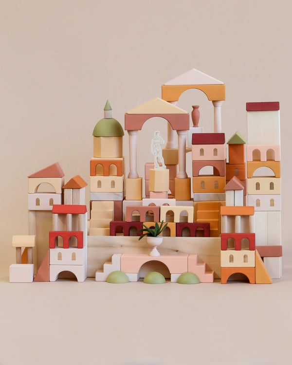 A beautifully arranged collection of Sabo Concept Italian Ancient City Blocks, shaped like various architectural structures including domes and archways, displayed in soft pastel colors reminiscent of Italian seaside towns.