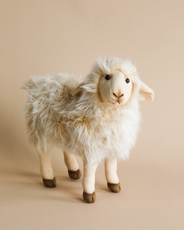 A handmade Sheep Stuffed Animal with fluffy white fur and a smiling face, standing against a soft beige background.