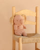 The Maileg Elephant, Small - Powder is a soft, light brown plush toy crafted from the gentlest fabric and features charming patterned ears. Seated on a woven wooden chair against a beige backdrop, it’s an adorable addition to any collection of Safari friends.