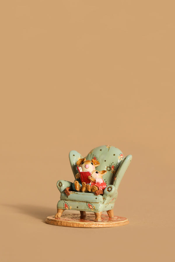 The Wee Forest Folk Tiny Collectible - Sharing A Story features a hand-sculpted mouse reading with a teddy bear in a green armchair, set against a plain beige background.