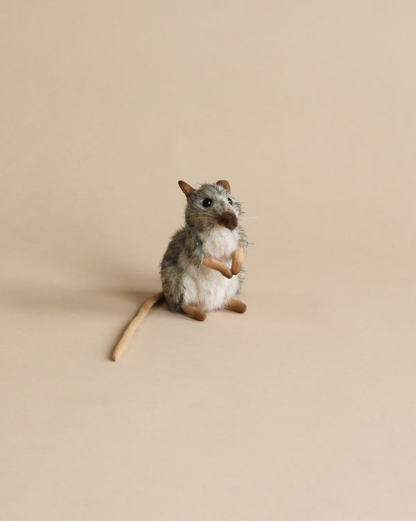 A small, realistic Mouse Stuffed Animal standing upright on its hind legs on a plain beige background. The mouse has artisan hand-sewn grey and beige fur, large ears, black eyes, and a curved tail.