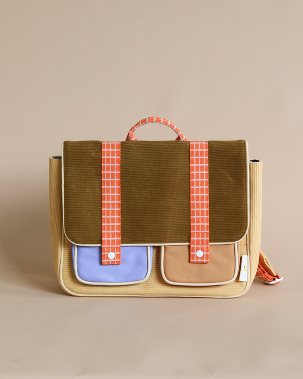 A stylish vertical messenger bag featuring a Corduroy Pear Jam body with blue and cream panels, and orange waterproof nylon straps with pink squares, standing against a light beige background.