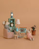 Two toy mice relax in a cozy Maileg scene featuring the Maileg Cozy Evening with Granddad Set, complete with a lamp, TV, potted plant, clock, and stylish furniture—all displayed on a beige background for charming miniature decor.