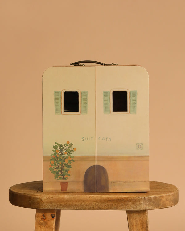 The Maileg SuitCasa—a suitcase styled as a little house with green shutters, a potted plant, and "Suit Casa"—makes a charming portable dollhouse for storing tiny treasures. Mice and furniture are sold separately.