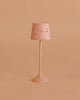 The Maileg Floor Lamp, Miniature - Dark Powder features a small pink stand and floral-patterned lampshade, making it perfect for dollhouse decor. Displayed against a simple beige background.