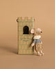 The Maileg Prince Mouse, Big Brother—a small cotton mouse in royal clothes and a crown—leans on a cardboard castle tower with a window and "Let the Story Begin" written on it. The background is light brown.