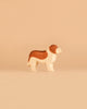 Standing on a beige background, the Ostheimer Handmade Wooden Dog Family Set features beautifully handcrafted brown and white wooden dog figurines, reflecting the quality and charm of Ostheimer toys made from sustainably sourced wood.