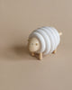 A Lacing Wooden Sheep shaped like a sheep with layered rings forming its body, standing on a beige background.