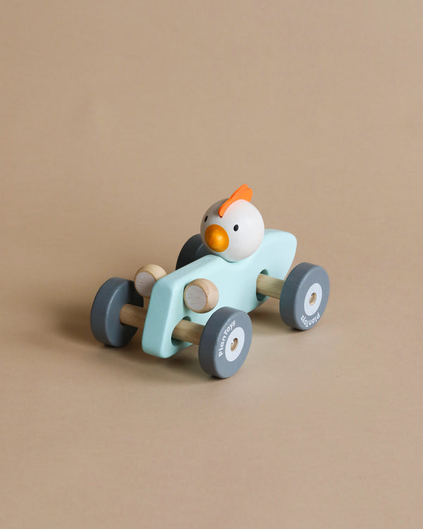 wooden race car toy with a chicken driver