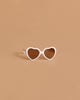 Minikane Doll Accessories | Loona Cream Heart Sunglasses: cream heart-shaped doll glasses with dark lenses, ideal for Minikane dolls, displayed on a solid light brown background.