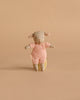 A Maileg Easter Egg with Lamb & Extra Clothing, featuring a small stuffed bunny in a pink knitted outfit, stands upright against a plain beige background.