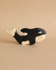 Part of the Holztiger Handmade Wooden Ocean Animals Set, this black and white wooden orca figure stands out against a plain beige background—a charming addition to any wooden animal collection.