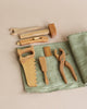 Seven wooden tool toys in a rollup canvas. 