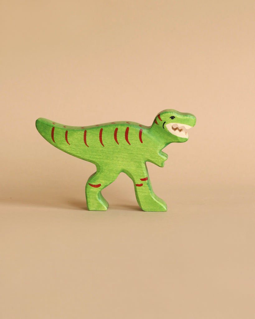 Holztiger Handmade Wooden Dinosaur Set green toy with red stripes and an open mouth.