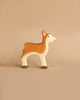 The Holztiger Handmade Wooden Woodland Animals Set features a brown and white deer, crafted from maple and beech wood, standing on a plain beige background.