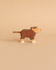 Handcrafted wooden Holztiger Handmade Wooden Highland Cow Family Set calf figure in brown with white feet and a textured tail.
