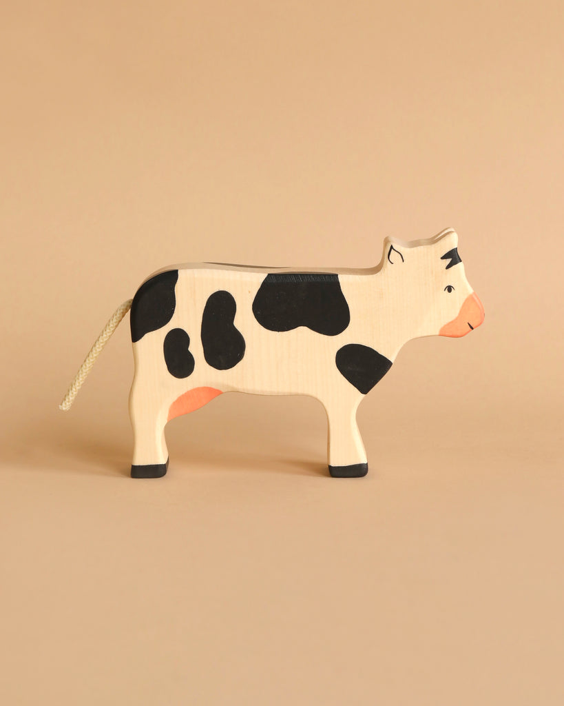 Holztiger Handmade Wooden Black & White Cow Family Set figure with black spots and a rope tail, perfect for imaginative play.