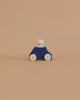 A Lubulona Wooden Car with Figure - Blue features a simple wooden toy figure and eco-friendly car with natural wheels, set against a plain beige background.