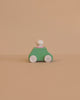 The Lubulona Wooden Car with Figure - Mint is a small, minimalist wooden toy car featuring a mint green body, white wheels, and a round white peg driver—an ideal eco-friendly kids toy set against a plain beige background.