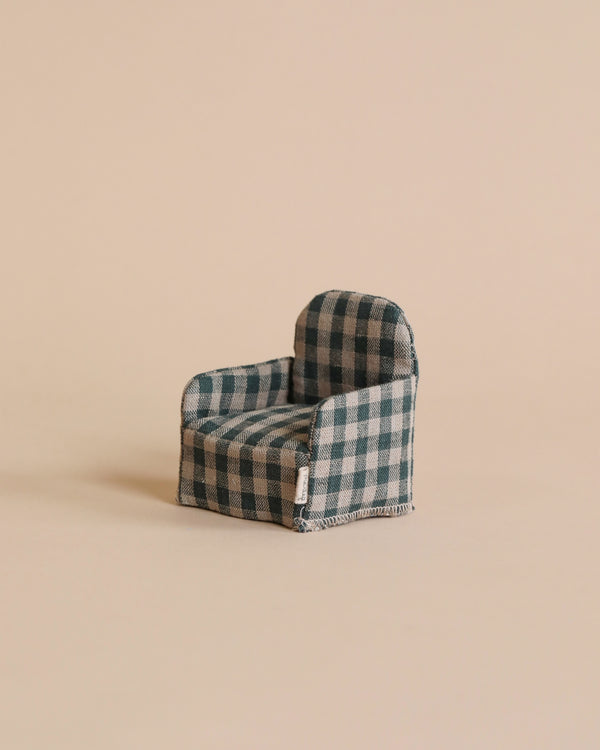 A miniature Maileg Plaid Chair, positioned against a soft beige background. The fabric chair features a structured design and visible seams.