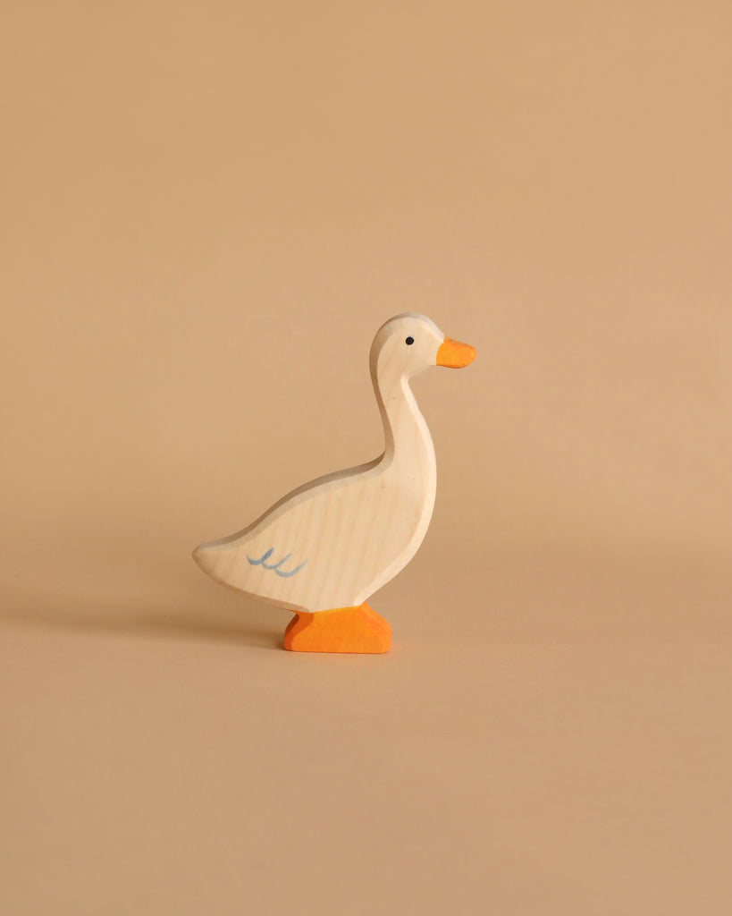 The Holztiger Handmade Wooden Woodland Animals Set features a charming handcrafted duck with an orange beak and feet, white body, and simple painted details—perfect for open-ended play and beautifully designed.
