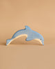 The Holztiger Handmade Wooden Sea Animals Set features a light blue dolphin, crafted from maple and beech wood with a natural underside—ideal for collectors and fans of quality wooden figures.