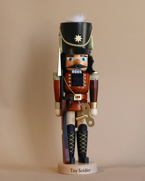 Introducing the Christian Ulbricht Nutcracker - Toy Soldier Limited Edition 5000, a traditional wooden nutcracker crafted as a toy soldier. This collectible piece features a bushy mustache and dons a classic red and black uniform, complete with a tall hat adorned with a star and feather. It stands upright on an elegant base labeled "Toy Soldier.