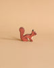A brown Holztiger squirrel figurine from the Handmade Wooden Woodland Animals Set, crafted from maple and beech wood with a bushy tail, is displayed on a plain beige background.