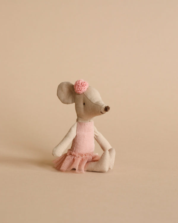 A Maileg | Ballerina Mouse - Big Sister in a pink tutu and a rose on its head, sitting against a plain beige background.