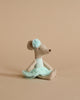 A handmade plush Maileg Ballerina Mouse - Little sister (Light Mint) in a sitting position, wearing a teal tutu and a matching flower on its ear, against a soft beige background.
