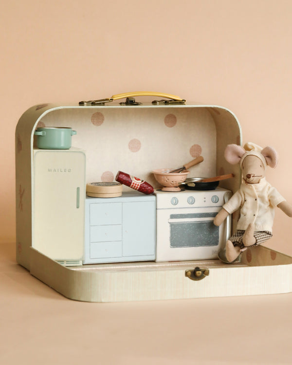 A miniature Maileg Chef's Kitchen Starter Set in a pastel-colored carrying case, complete with a toy stove, sink, utensils, and a chef mouse toy, set against a soft peach background.