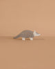 The Holztiger Armadillo is a small, gray wooden figurine with black spots and a white face, handcrafted in Europe, capturing the charm and quality of classic HOLZTIGER toys.
